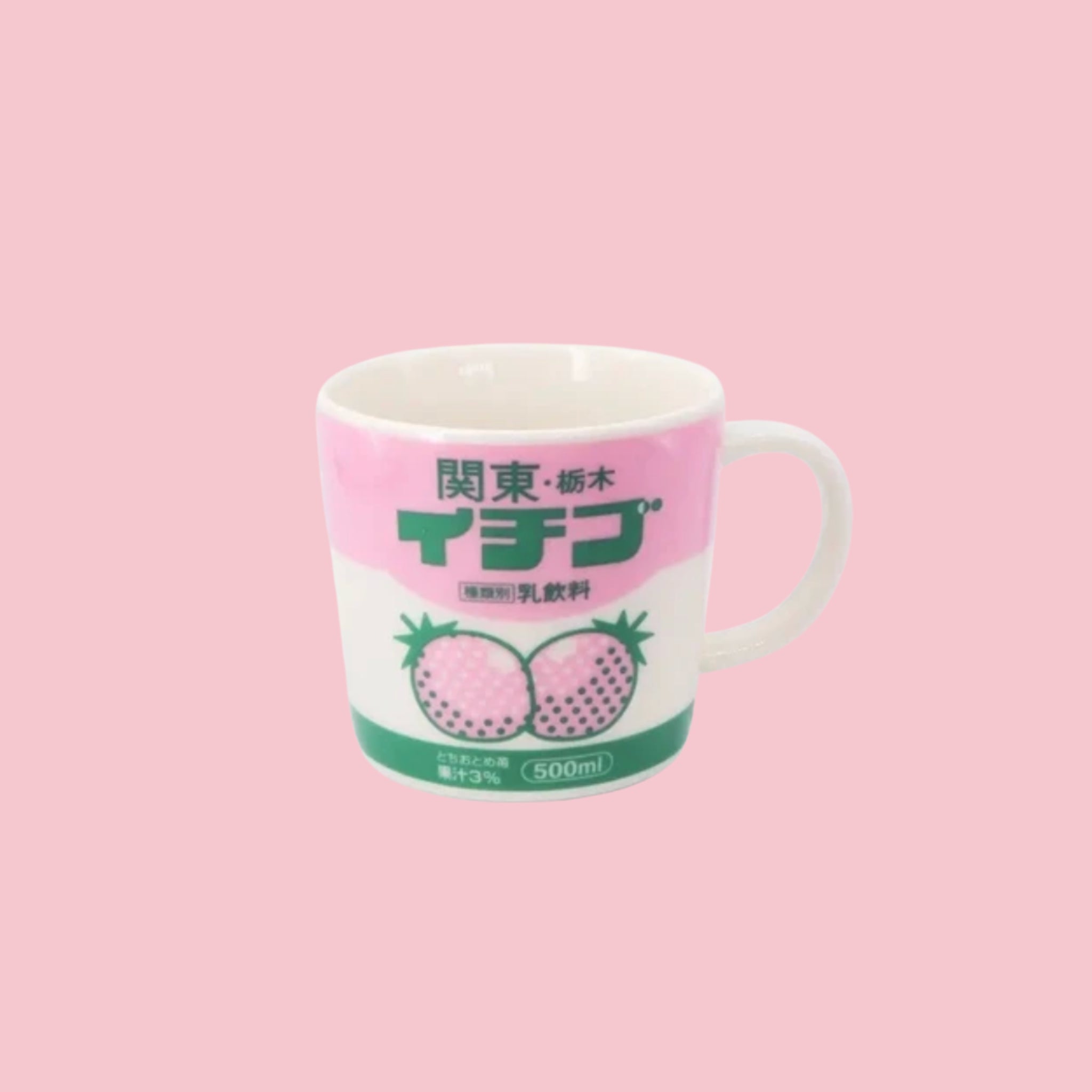 A white ceramic mug featuring a retro Japanese label design with pink and white colorblocking, bold green text reading 関東・栃木 イチゴ (Kanto Tochigi Strawberry), illustrated strawberries, and 500ml strawberry milk drink branding, displayed on a pink background.