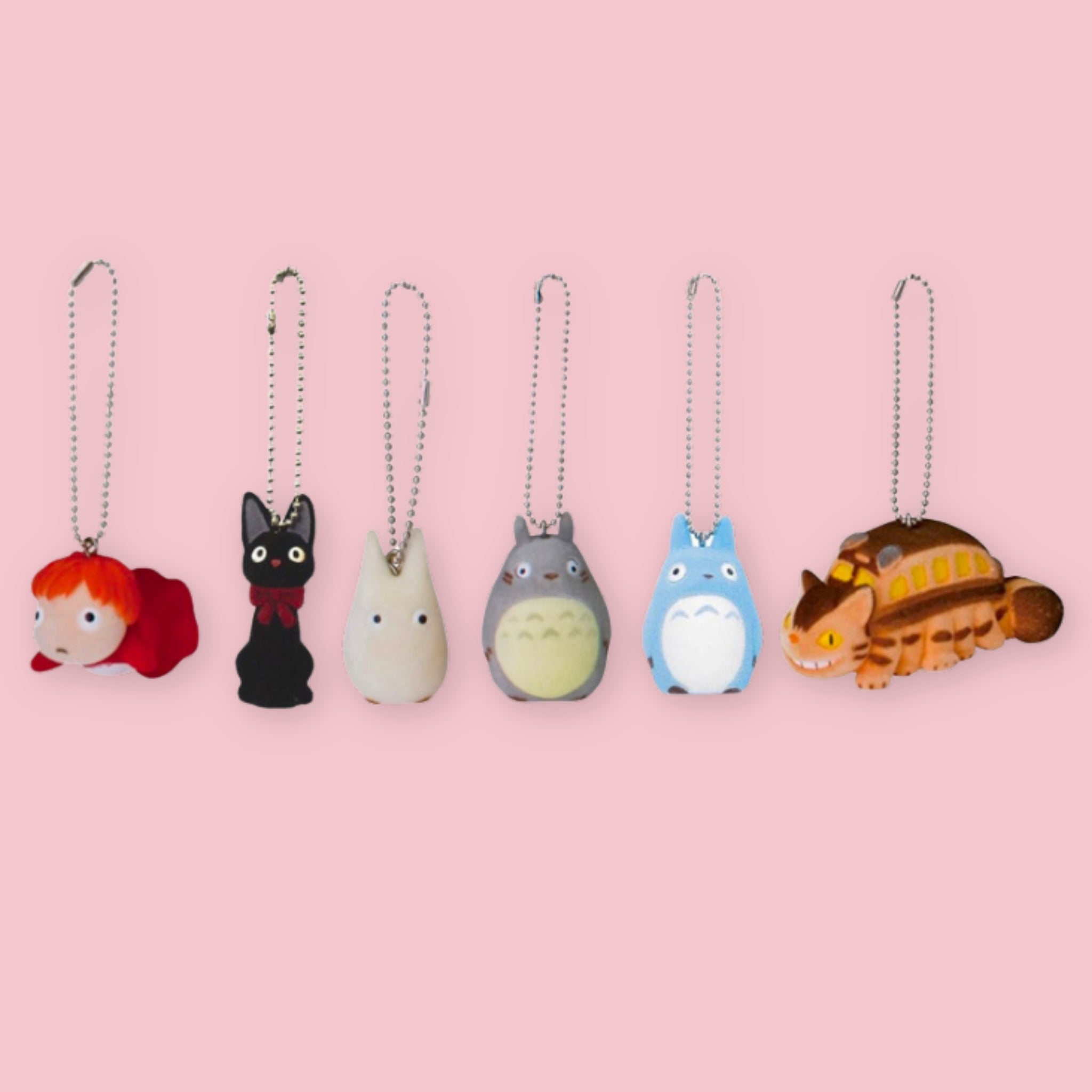 Studio Ghibli flocked charm keychains featuring Ponyo, Jiji, white Totoro, gray Totoro, blue Totoro, and Catbus on a pink background.