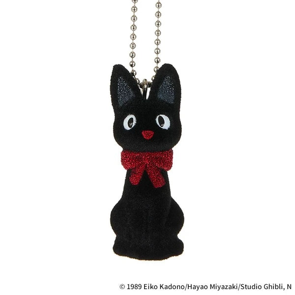 Studio Ghibli Jiji flocked charm keychain with red bow and ball chain, shown on a white background.