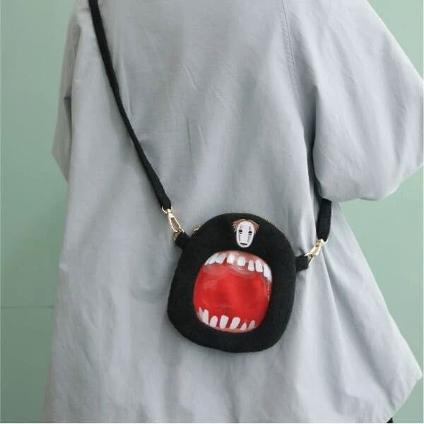 No-Face Spirited Away plush outing pouch worn as a small crossbody bag.