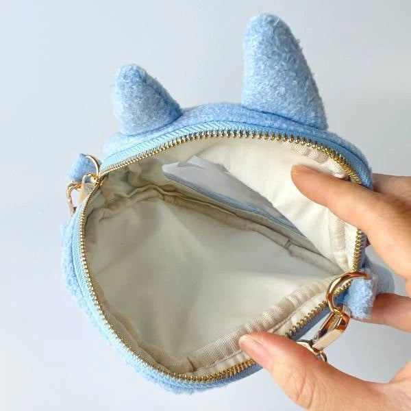 Open blue Totoro plush outing pouch showing the zippered main compartment and fabric lining.