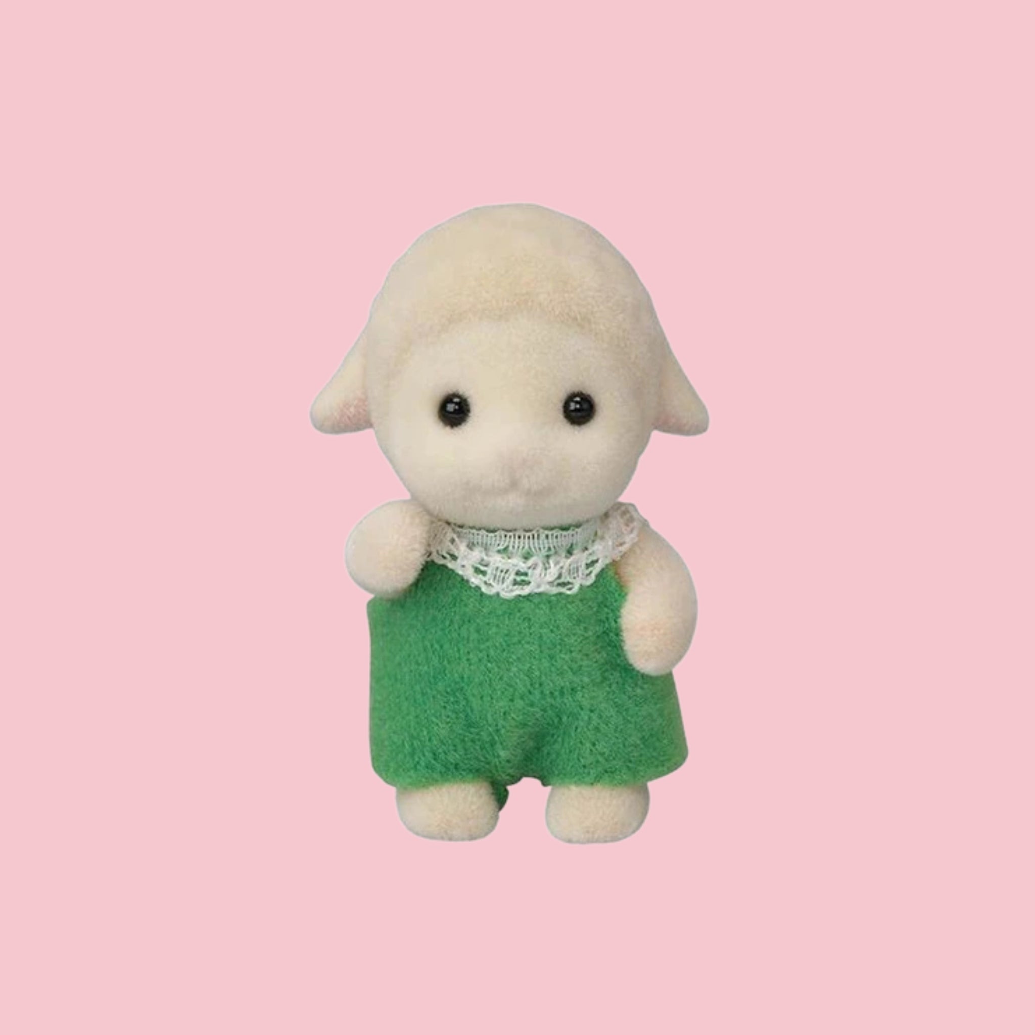 Sylvanian Families sheep baby figure in green outfit, shown against a pink background.