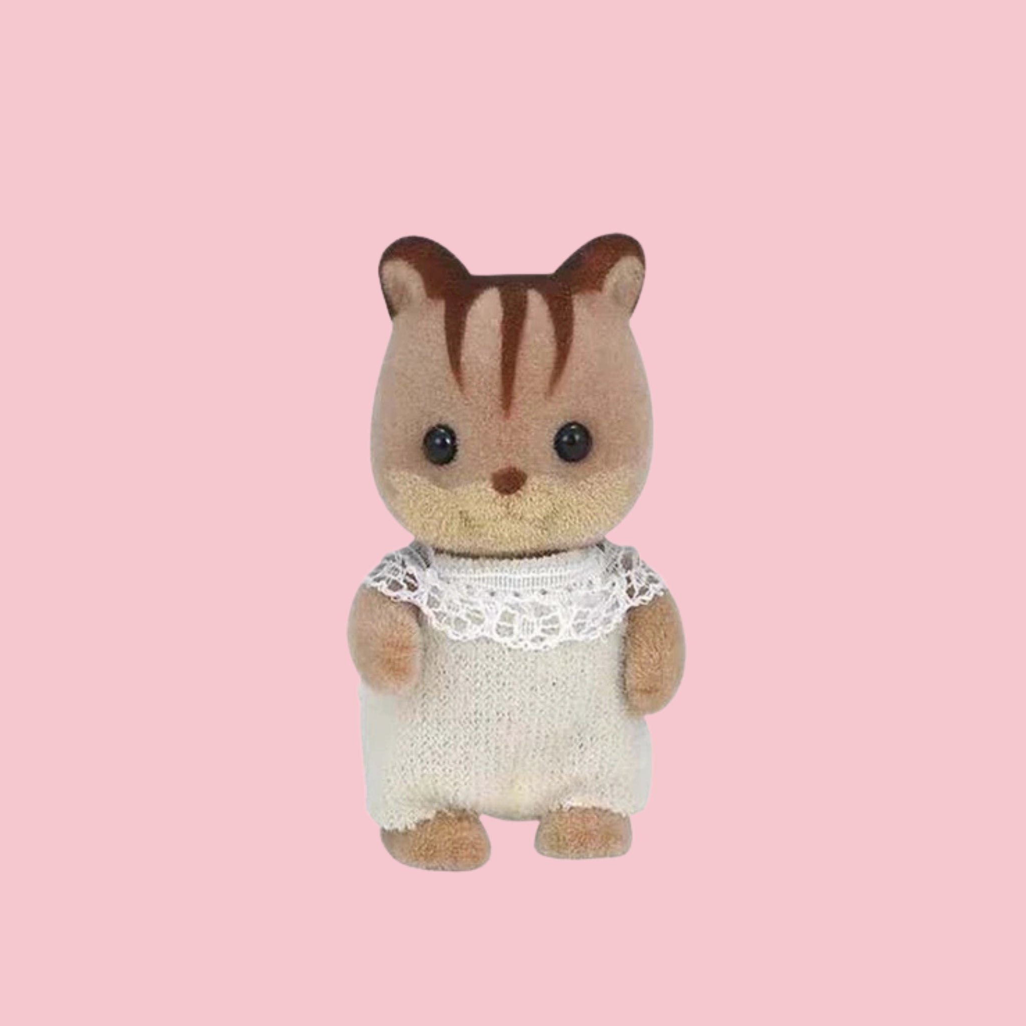 Sylvanian Families walnut squirrel baby figure in green outfit, shown against a pink background.