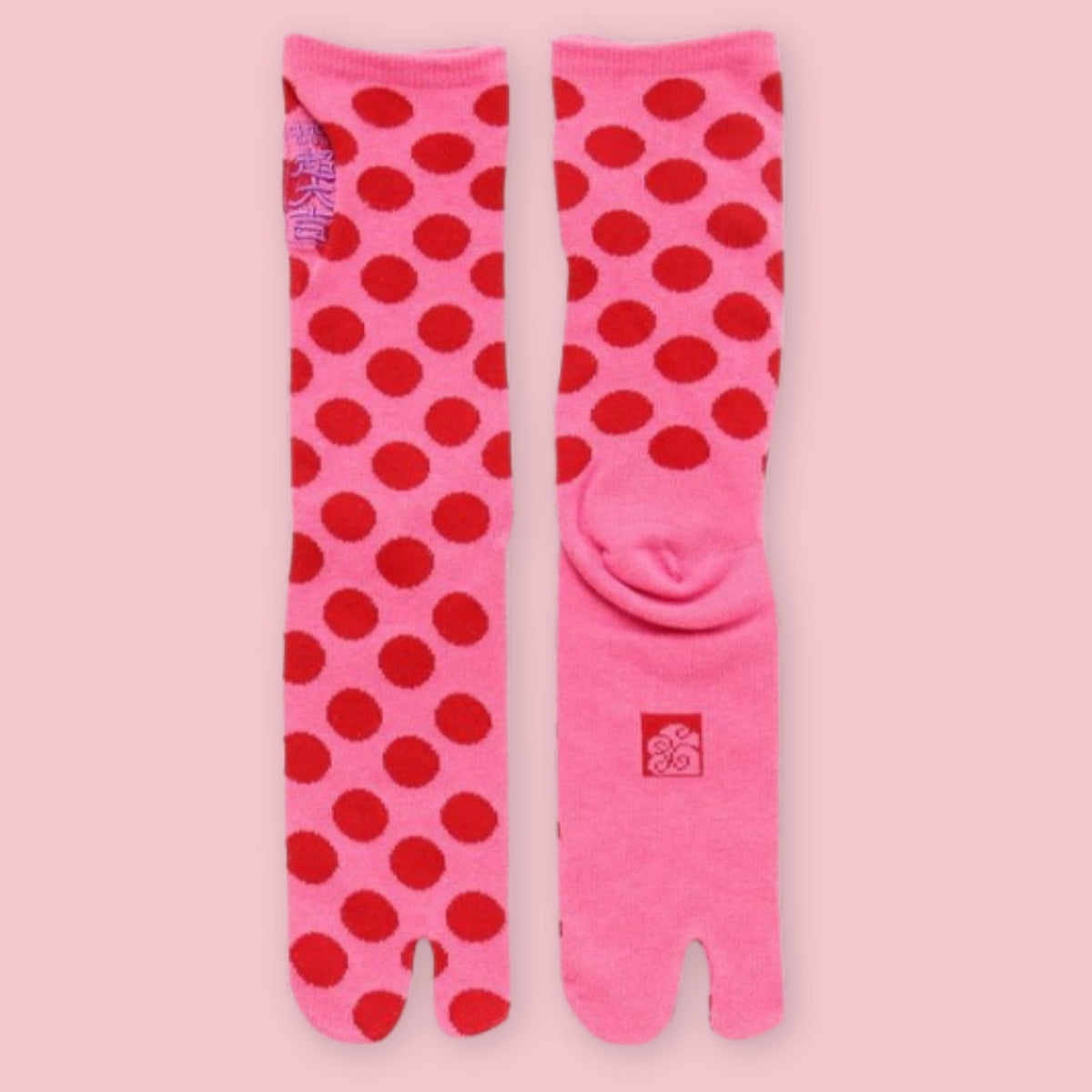 Pink Japanese tabi socks with red polka dots and split toes, shown front and back.