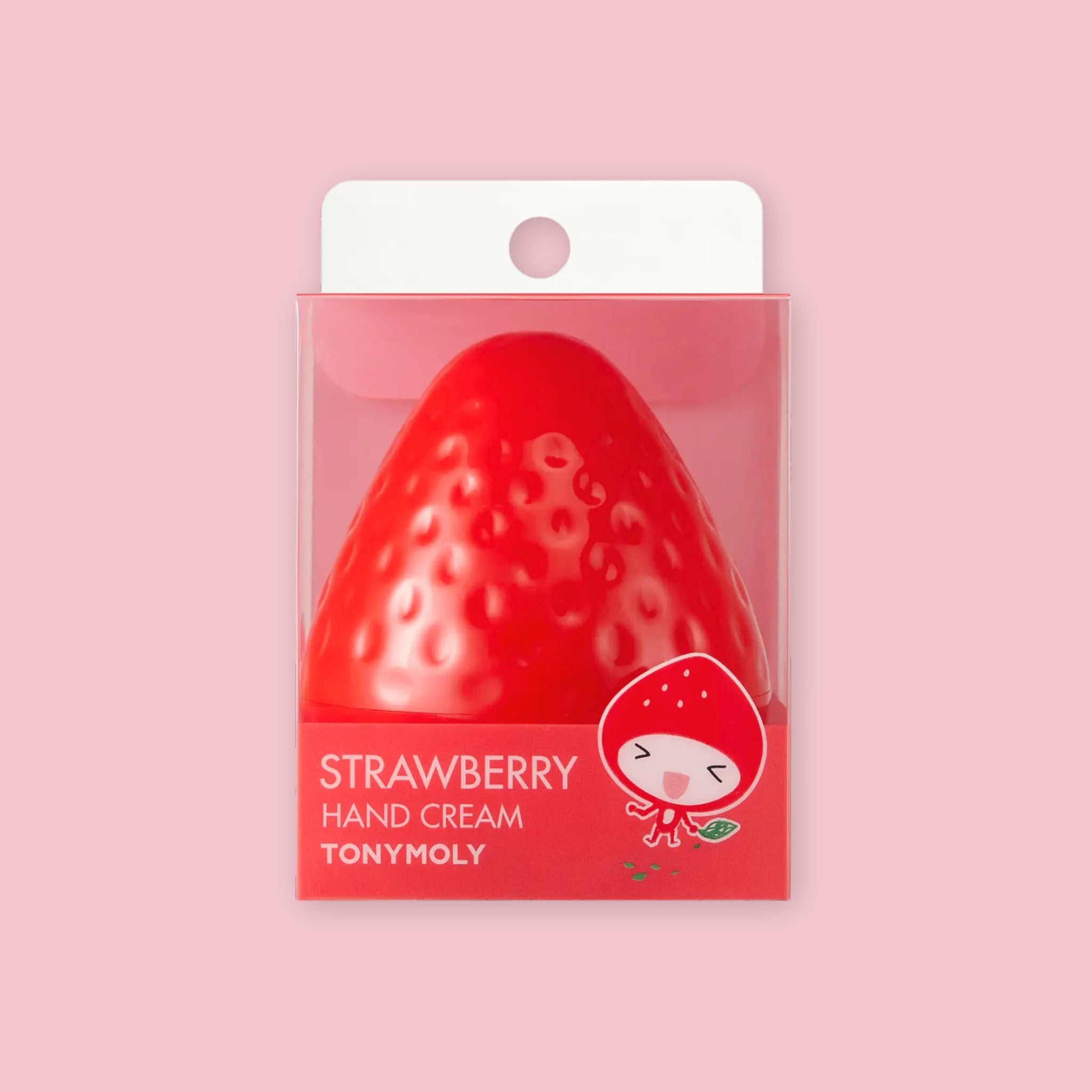 TonyMoly Strawberry Hand Cream shown in its strawberry-shaped retail packaging with a smiling strawberry character illustration, on a pink background.