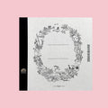 Square Tsubame notebook featuring Moomin illustrations, with a textured white cover, black spine, and detailed woodland wreath border surrounding blank label lines in the center. The monochrome artwork includes Moomin characters, plants, and nature scenes.