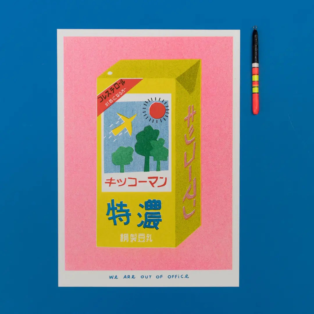 We Are Out of Office risograph art print featuring a yellow Japanese soy milk carton illustration on a pink background, photographed on blue with a small charm.