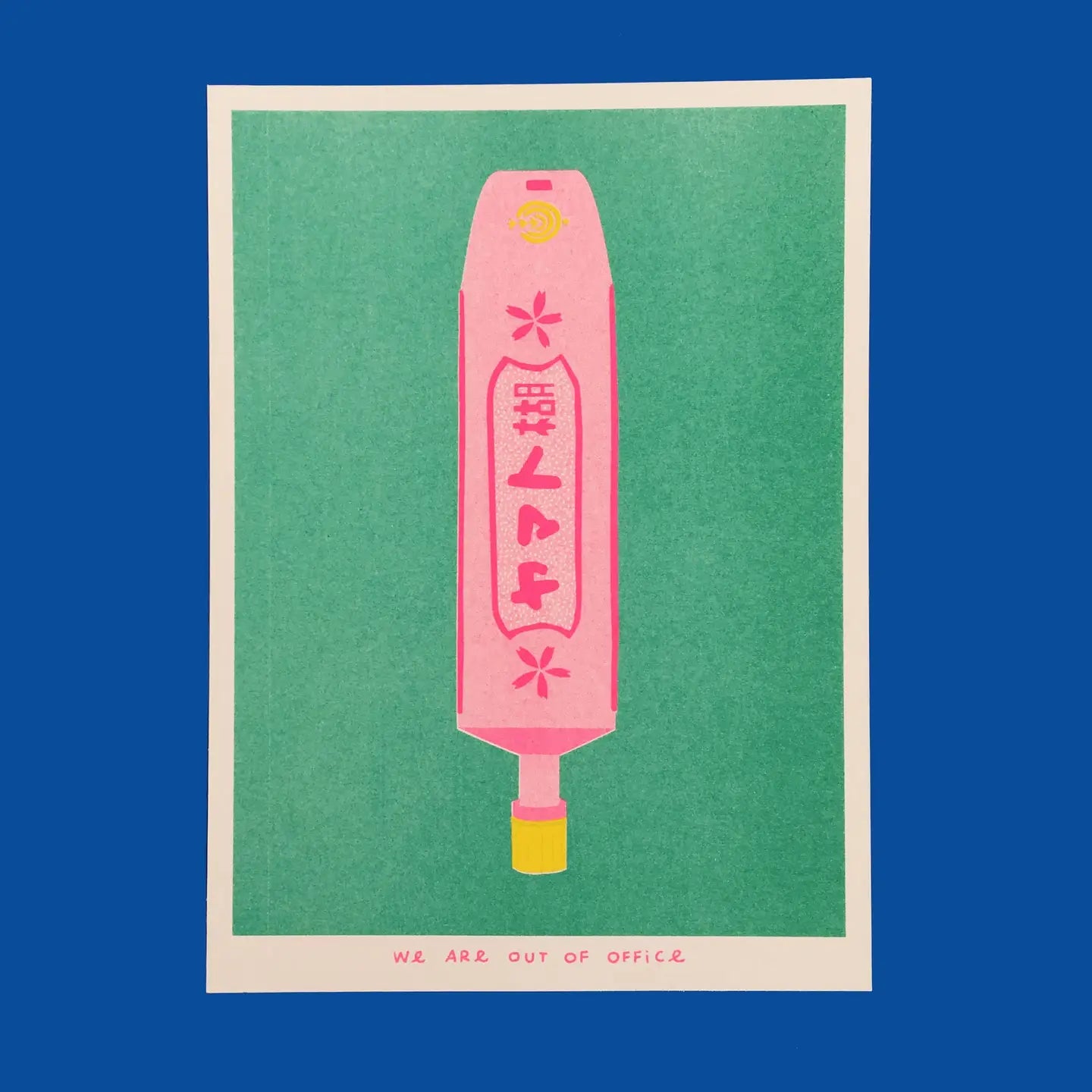 We Are Out of Office risograph art print featuring a pink Japanese glue tube illustration on a green background, photographed against blue.