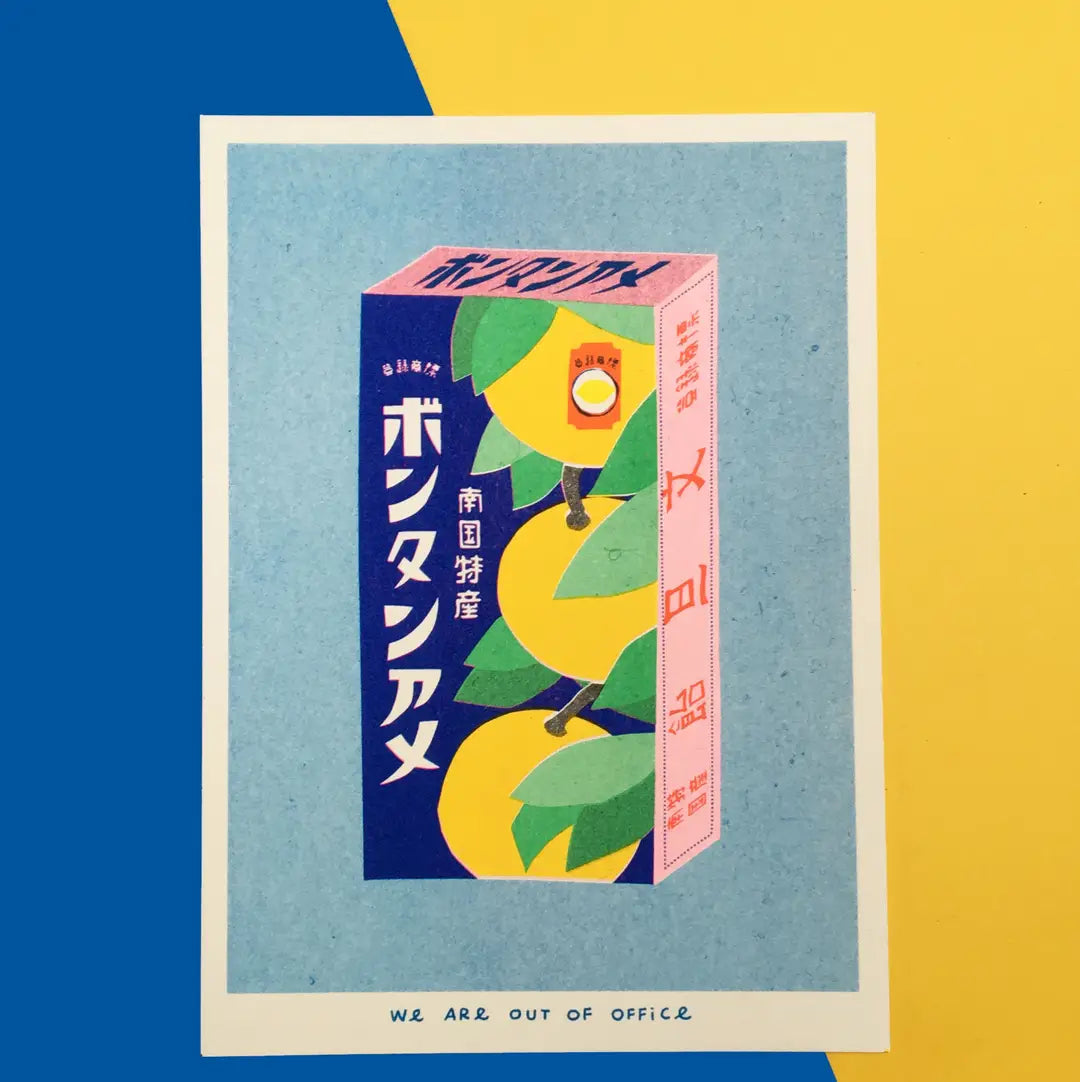 We Are Out of Office risograph art print featuring a Japanese candy box illustration with yellow fruit and blue packaging, photographed on a blue and yellow background.
