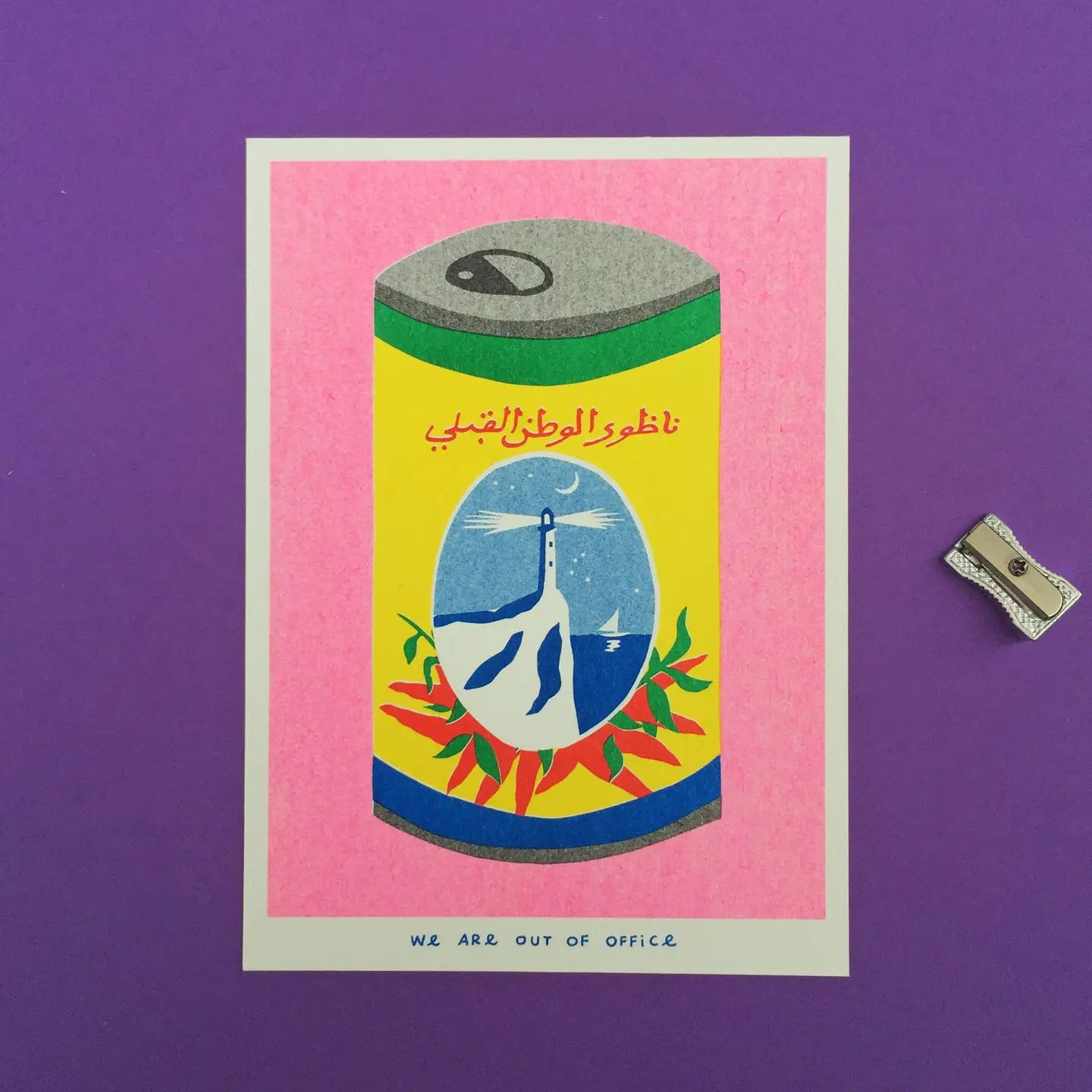 We Are Out of Office risograph art print featuring a colorful harissa can illustration with Arabic text, photographed on a purple background with a pencil sharpener.