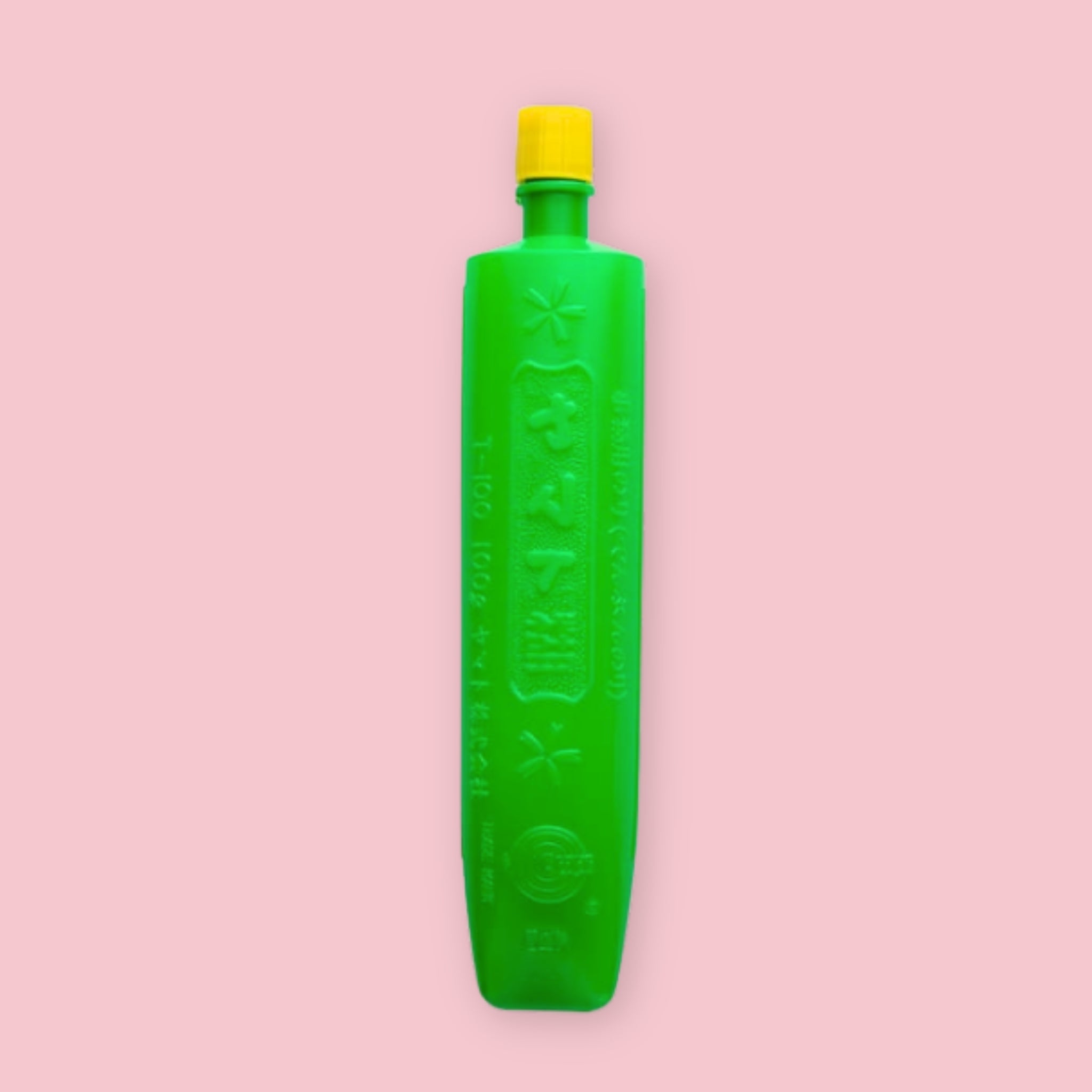 Yamato Nori paste in a tall green bottle with a yellow cap and embossed Japanese text, on a pink background.